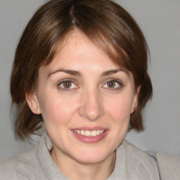 Joyful white young-adult female with medium  brown hair and blue eyes