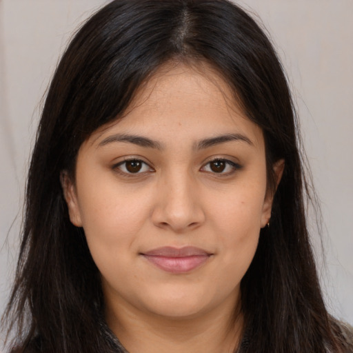 Joyful latino young-adult female with long  brown hair and brown eyes