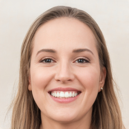 Joyful white young-adult female with long  brown hair and grey eyes