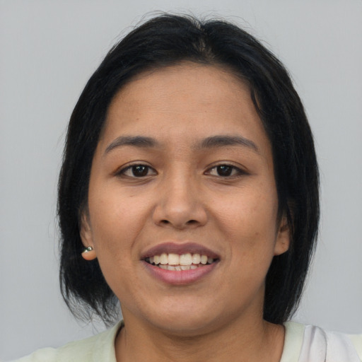 Joyful asian young-adult female with long  brown hair and brown eyes