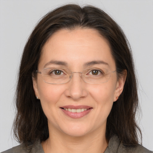 Joyful white adult female with medium  brown hair and brown eyes