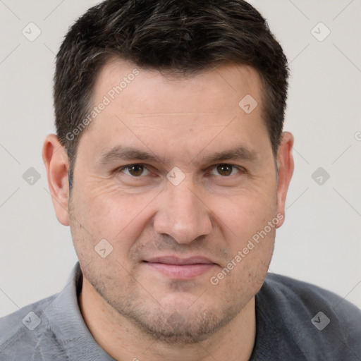 Joyful white adult male with short  brown hair and brown eyes