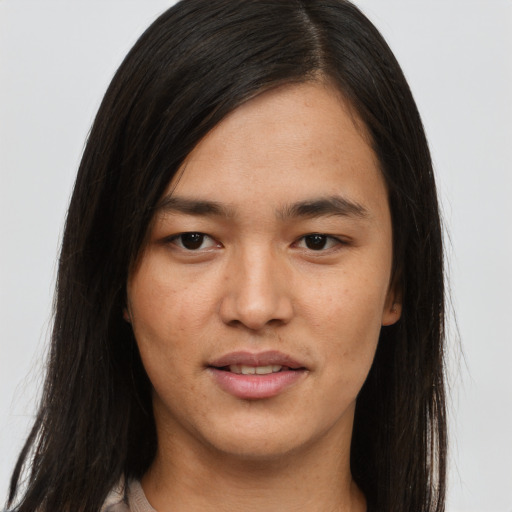 Joyful asian young-adult female with long  brown hair and brown eyes