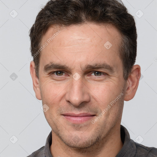 Joyful white adult male with short  brown hair and brown eyes