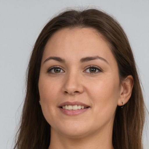 Joyful white young-adult female with long  brown hair and brown eyes