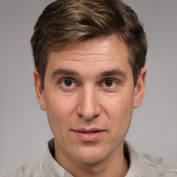 Joyful white adult male with short  brown hair and brown eyes