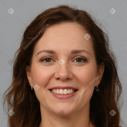 Joyful white adult female with long  brown hair and brown eyes