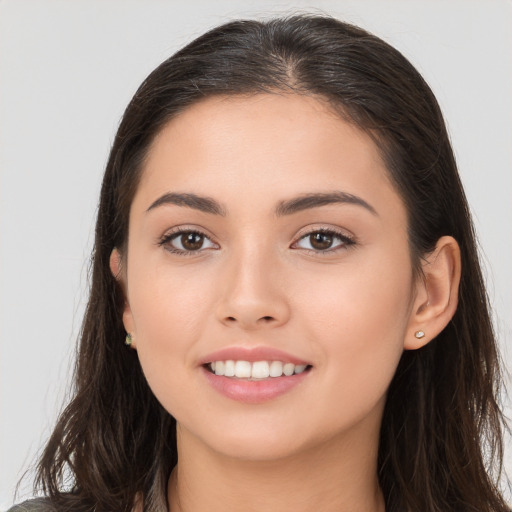 Joyful white young-adult female with long  brown hair and brown eyes