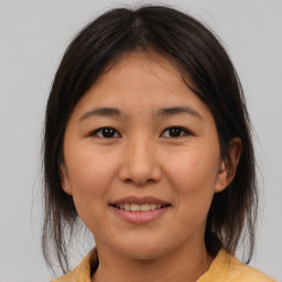 Joyful asian young-adult female with medium  brown hair and brown eyes