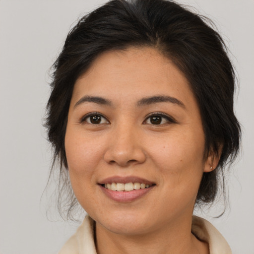 Joyful asian young-adult female with medium  brown hair and brown eyes