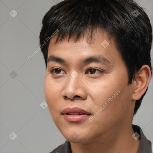 Joyful asian young-adult male with short  black hair and brown eyes