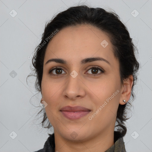 Joyful latino young-adult female with long  brown hair and brown eyes