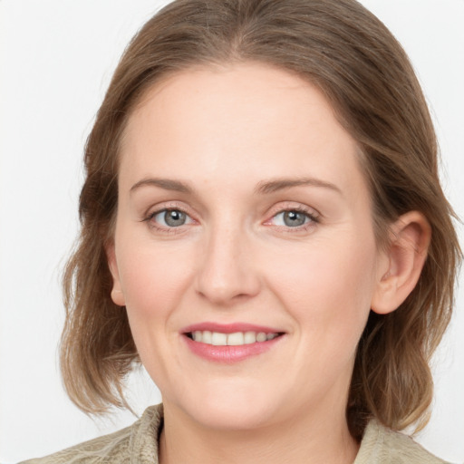 Joyful white young-adult female with medium  brown hair and blue eyes