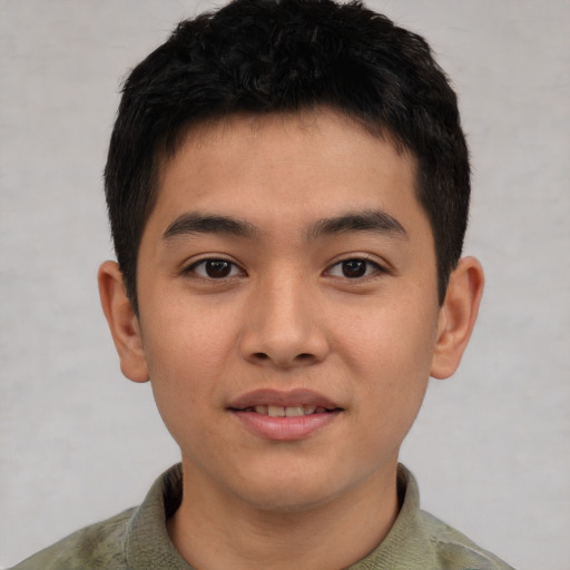 Joyful asian young-adult male with short  brown hair and brown eyes