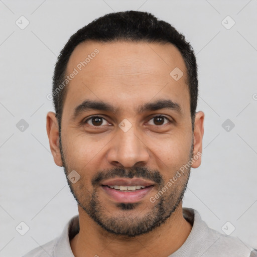 Joyful latino young-adult male with short  black hair and brown eyes