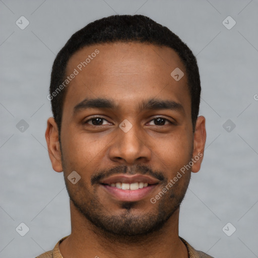 Joyful black young-adult male with short  black hair and brown eyes