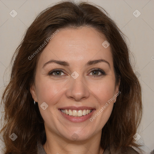 Joyful white adult female with long  brown hair and brown eyes