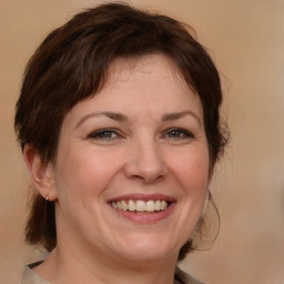 Joyful white adult female with medium  brown hair and brown eyes