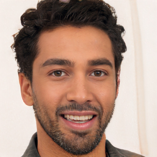 Joyful white young-adult male with short  black hair and brown eyes