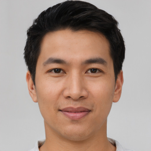 Joyful asian young-adult male with short  black hair and brown eyes