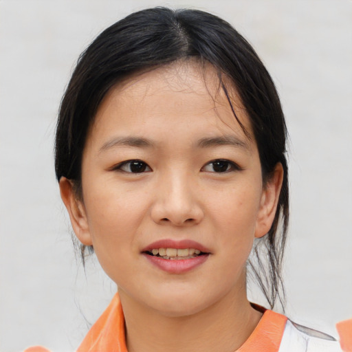 Joyful asian child female with medium  brown hair and brown eyes