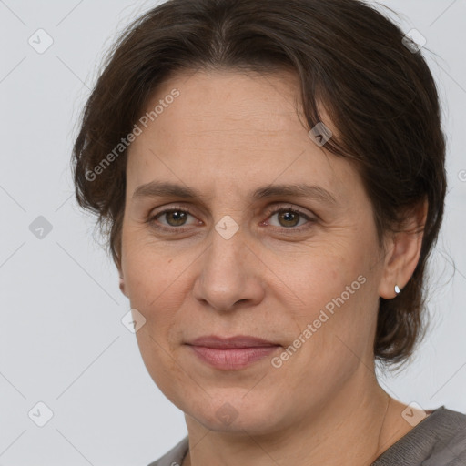 Joyful white adult female with medium  brown hair and brown eyes