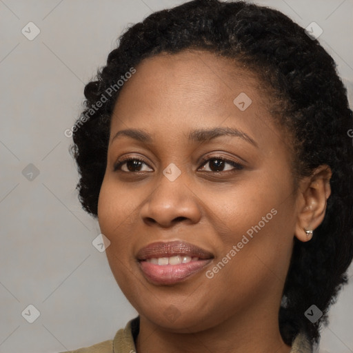 Joyful black young-adult female with long  black hair and brown eyes