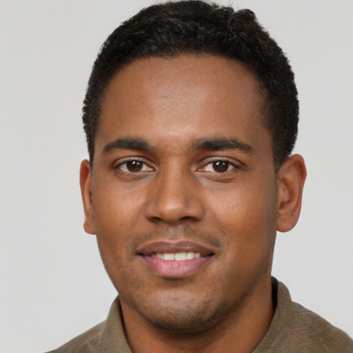Joyful black young-adult male with short  brown hair and brown eyes