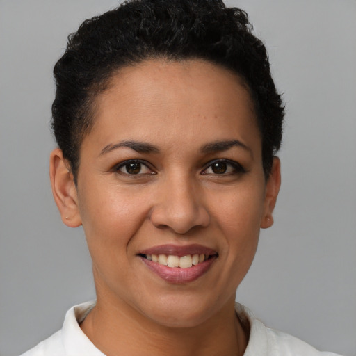 Joyful latino young-adult female with short  brown hair and brown eyes