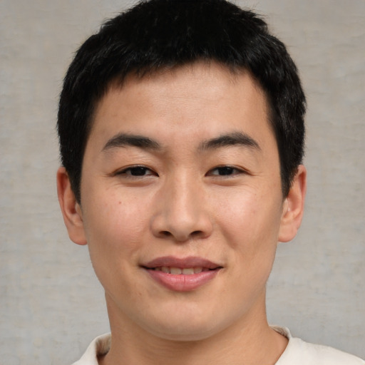 Joyful asian young-adult male with short  brown hair and brown eyes