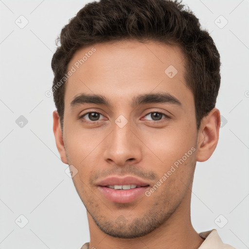 Joyful white young-adult male with short  brown hair and brown eyes