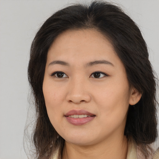 Joyful asian young-adult female with long  brown hair and brown eyes