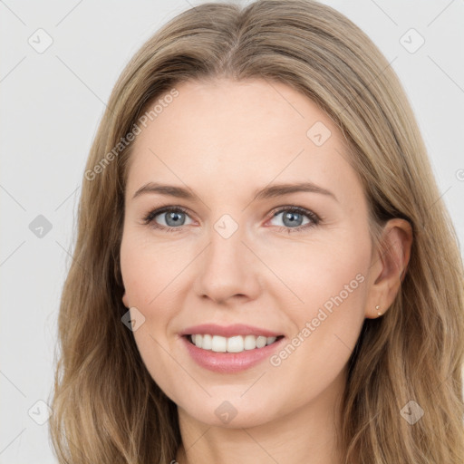 Joyful white young-adult female with long  brown hair and blue eyes