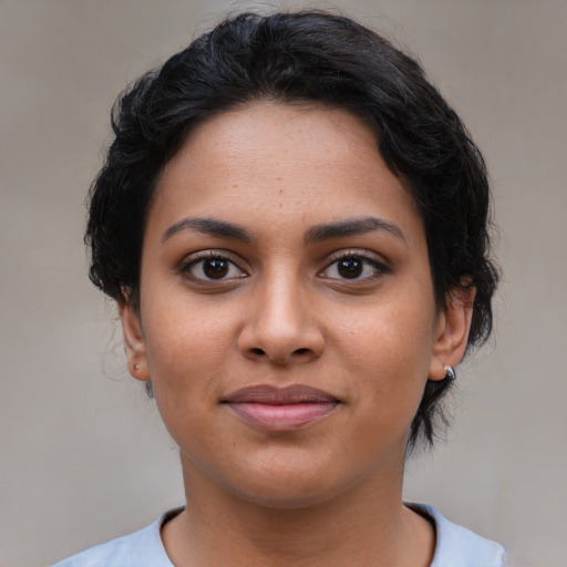 Joyful latino young-adult female with short  brown hair and brown eyes