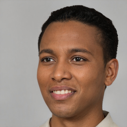 Joyful black young-adult male with short  brown hair and brown eyes