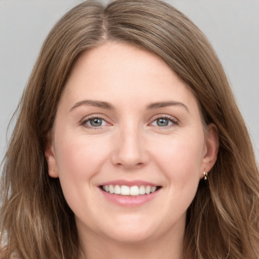 Joyful white young-adult female with long  brown hair and grey eyes