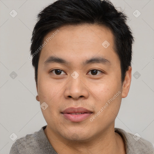 Joyful asian young-adult male with short  black hair and brown eyes