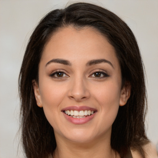 Joyful white young-adult female with long  brown hair and brown eyes