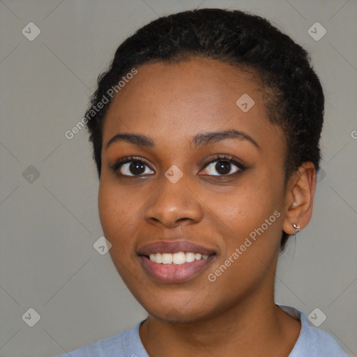 Joyful black young-adult female with short  black hair and brown eyes