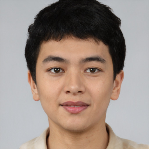 Joyful asian young-adult male with short  black hair and brown eyes
