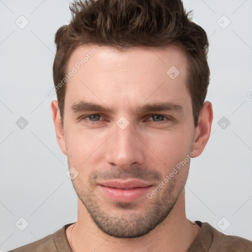 Joyful white young-adult male with short  brown hair and grey eyes