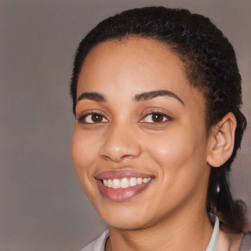 Joyful latino young-adult female with short  black hair and brown eyes