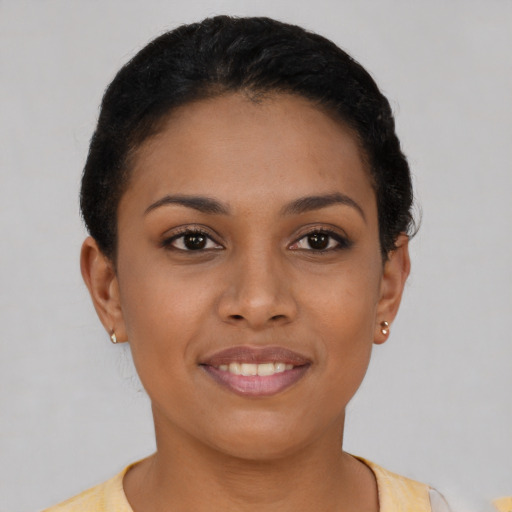 Joyful latino young-adult female with short  brown hair and brown eyes