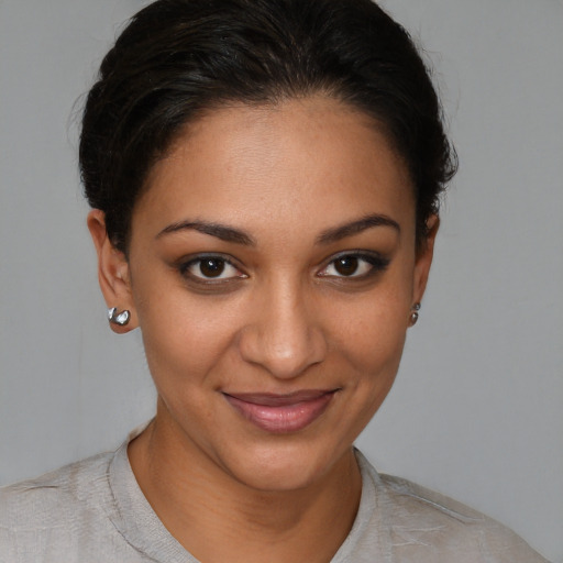 Joyful black young-adult female with short  brown hair and brown eyes