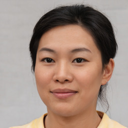 Joyful asian young-adult female with short  brown hair and brown eyes