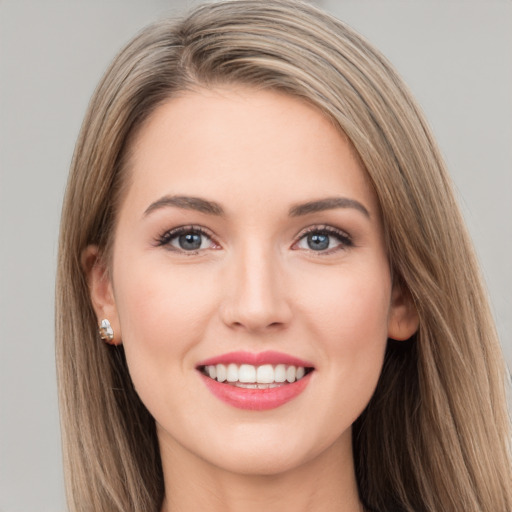 Joyful white young-adult female with long  brown hair and grey eyes