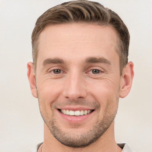 Joyful white young-adult male with short  brown hair and brown eyes