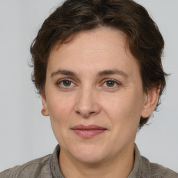 Joyful white adult female with short  brown hair and brown eyes