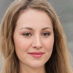 Joyful white young-adult female with long  brown hair and green eyes