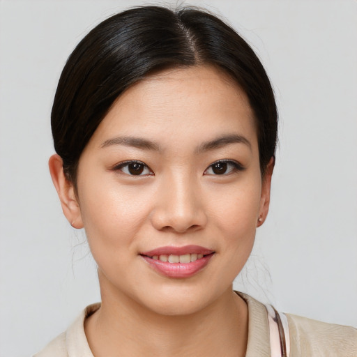 Joyful asian young-adult female with medium  brown hair and brown eyes